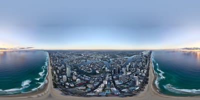 Aerial view of a coastal city with water and buildings.