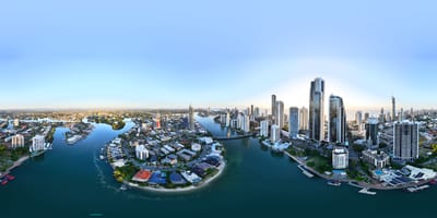 A panoramic view of a city skyline with waterways and buildings.